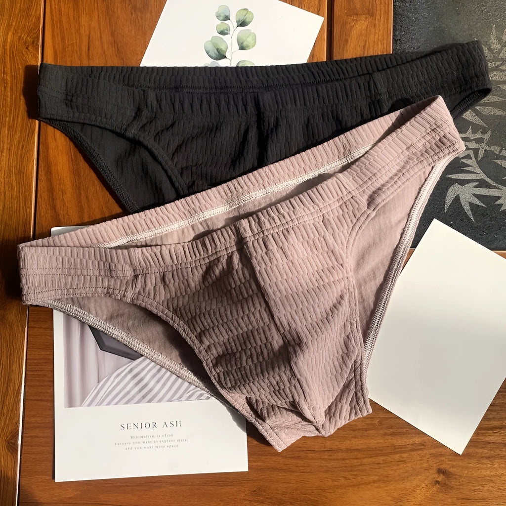 Men's solid colour cotton triangle briefs with a mid-waist waistband on a white background.