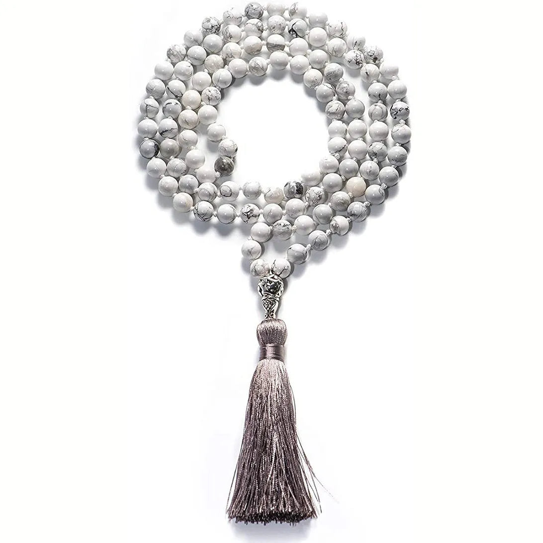Long agate tassel necklace with geometric stone beads in various colours on a neutral background.