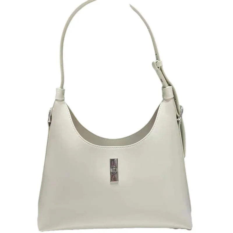 A soft genuine leather dumpling-shaped crossbody shoulder bag in a street style, shown with internal phone pocket.