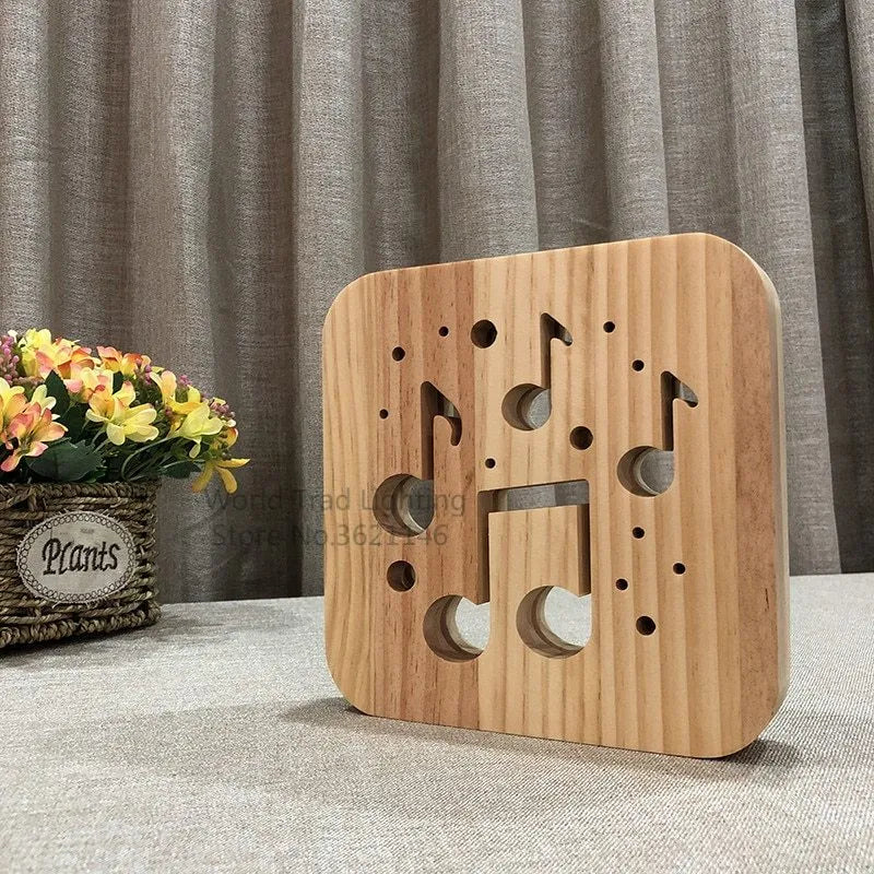Square wooden LED atmosphere lamp with warm white light and USB cable on a desk