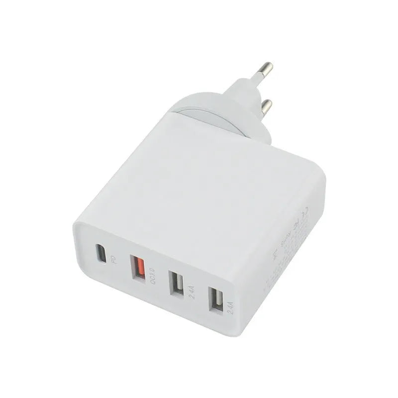 Black four-port USB-C wall charger with UK plug adapter and international travel plugs
