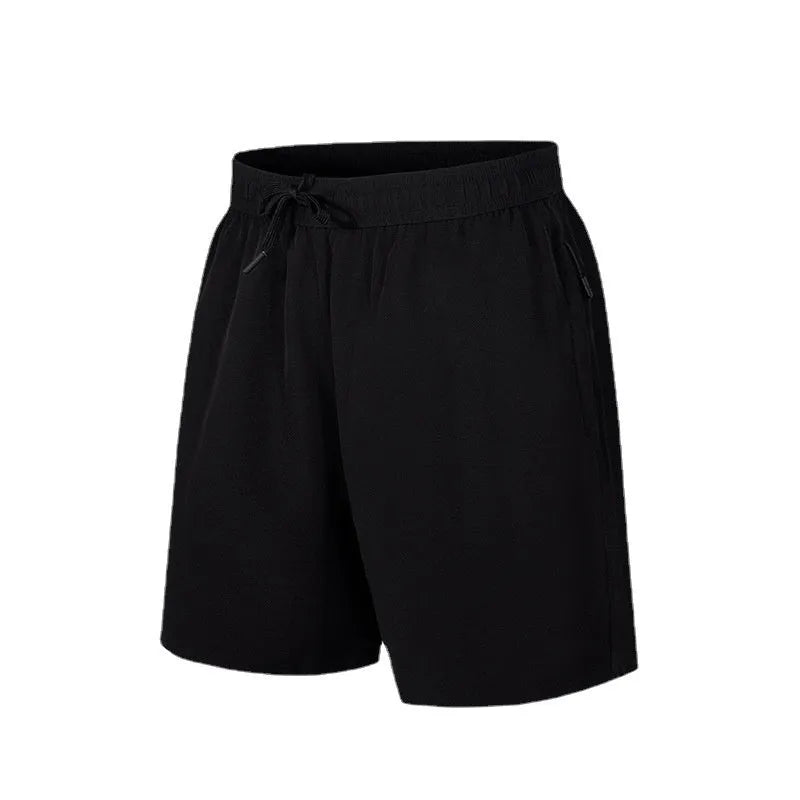 Man wearing loose black quick-dry sports shorts with an elastic waistband