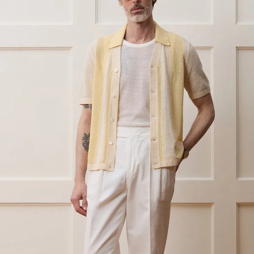Yellow casual polo shirt with asymmetric hollow-out design and short sleeves.
