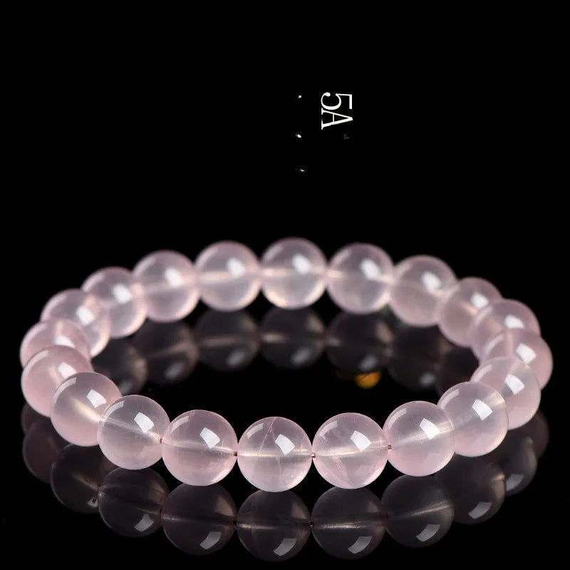 Women's natural style bracelet with round polished crystal beads in pink, showing size options from small to large beads.