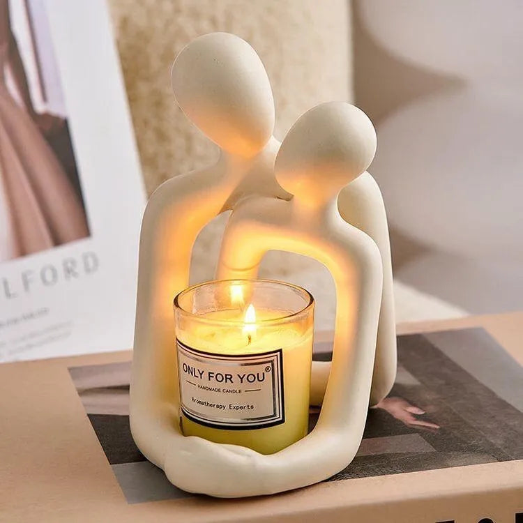 Modern minimalist loving couple resin statue in Gold or Milky White finish on a wooden surface.
