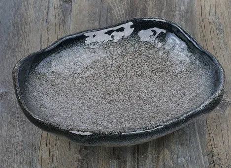 Japanese ceramic sashimi bowl with irregular shape and floral decoration pattern
