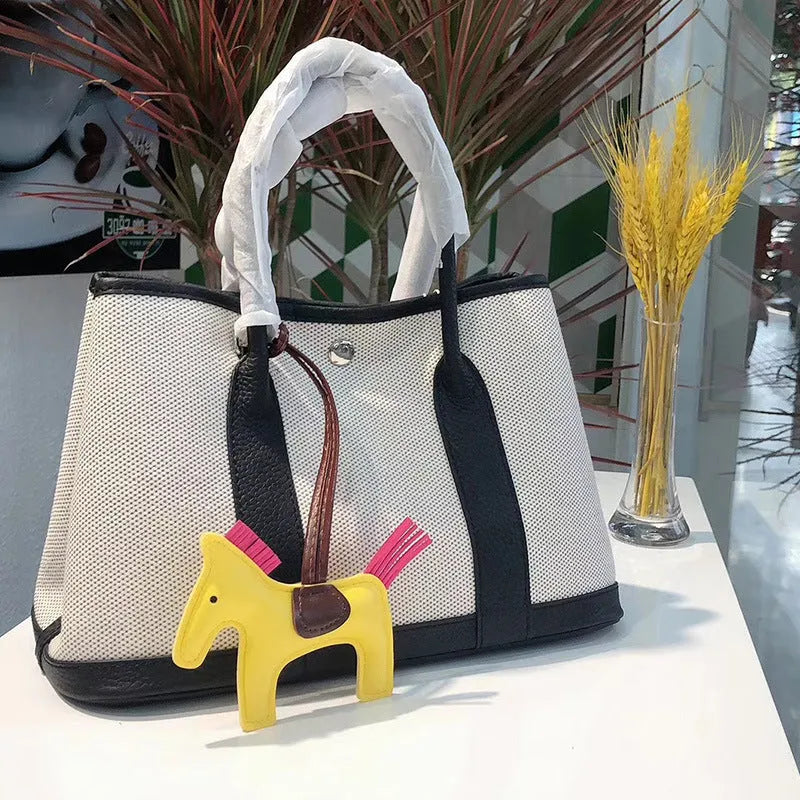 Genuine leather women's crossbody tote bag with canvas lining in bucket shape