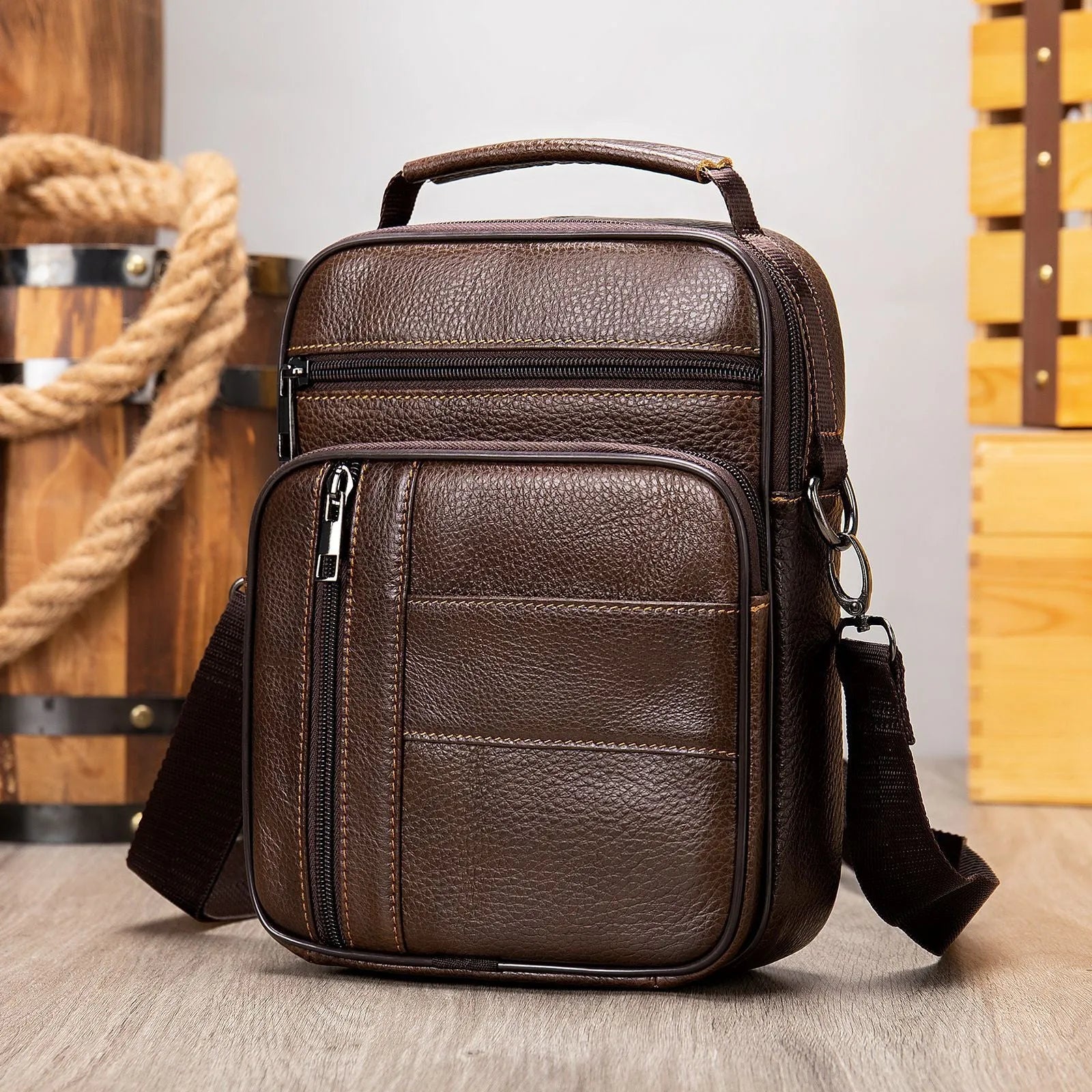 Men's vintage brown genuine cowhide leather vertical square shoulder bag with a zipper.