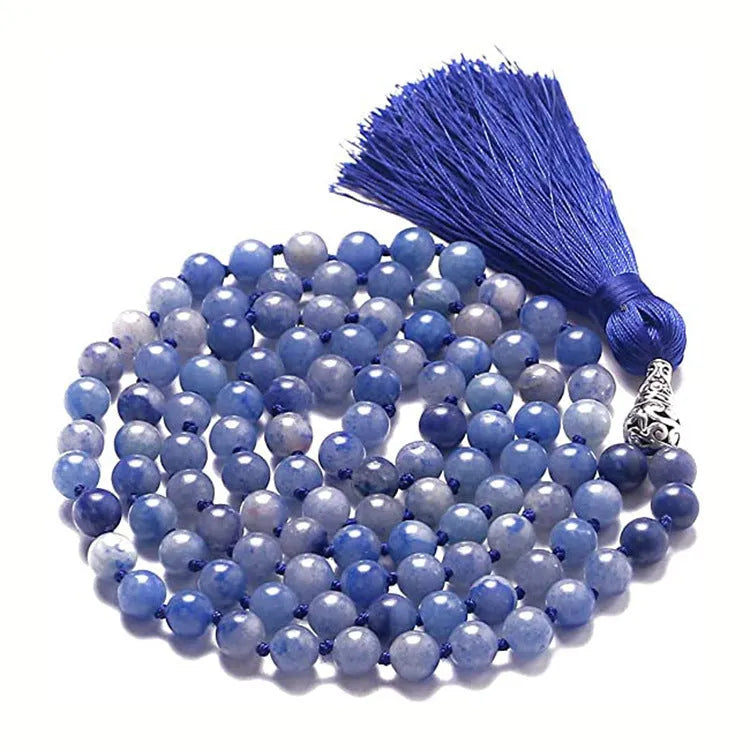 Long agate tassel necklace with geometric stone beads in various colours on a neutral background.