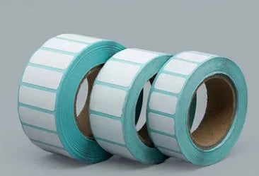 Roll of waterproof black and blue sticky sticker labels 20mm x 10mm 3000 sheets double row horizontal layout on table