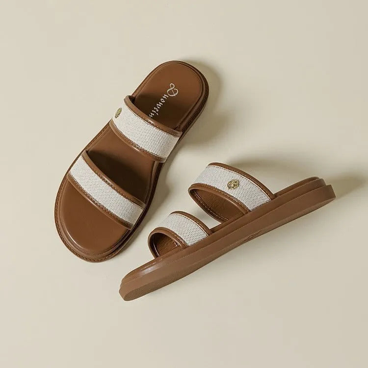 Women's brown retro soft bottom flip-flops with an artificial PU upper on a plain background.