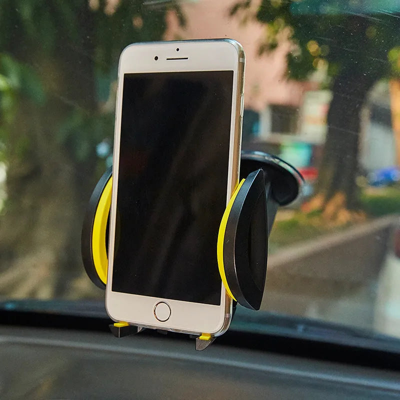 Red U-shaped suction cup car phone holder with automatic locking clamp arms on a dashboard.