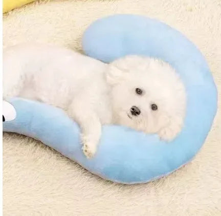 Blue question mark shaped cloth pillow for cat neck support on a pet sleeping mat