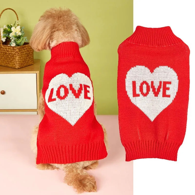 Dog wearing acrylic jumper with love heart and bow designs in red and pink colour patterns