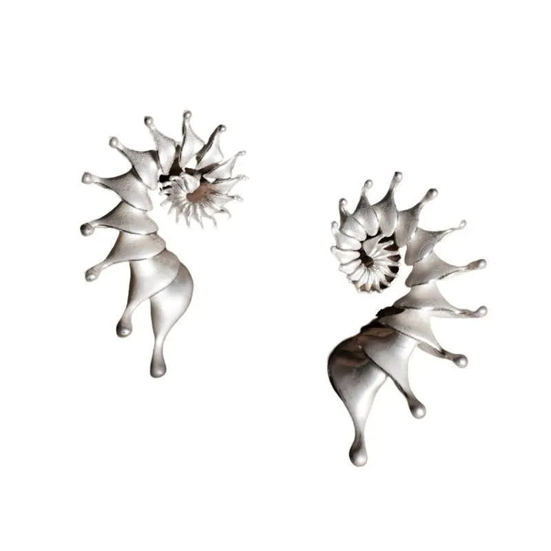 Conch ear studs with exaggerated three-dimensional matte finish and irregular geometric shape