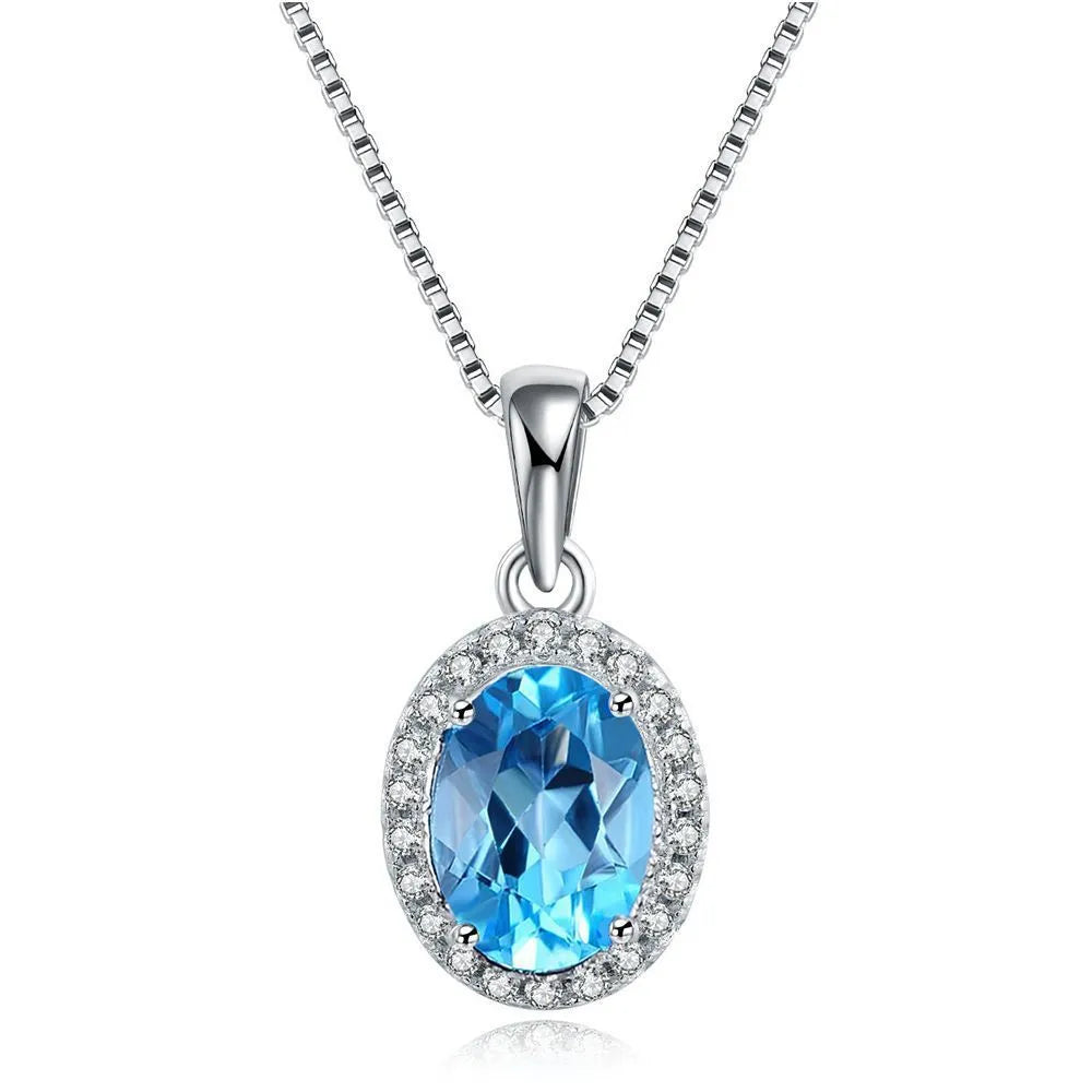 Four-piece 925 Sterling Silver geometric jewellery set with blue topaz gems, showing earrings, ring, pendant, and necklace.