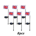 Solar garden flag light with stainless steel pole showing American flag design illuminated at night