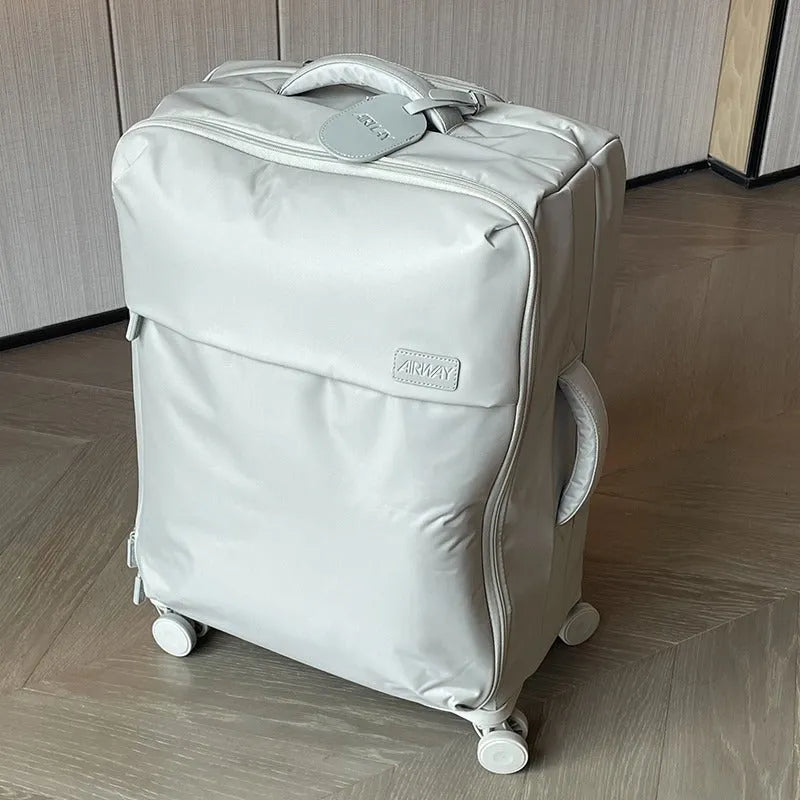 Ultra-light waterproof Oxford cloth suitcase with universal wheels in a bluestone green colour.