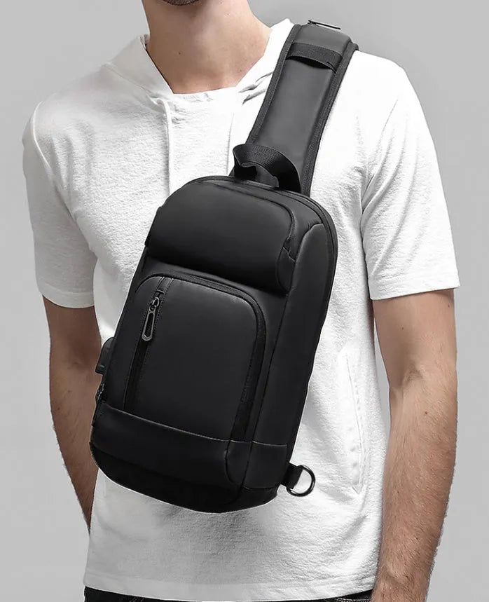 Black outdoor shoulder bag showing internal computer pocket and air cushion shoulder strap