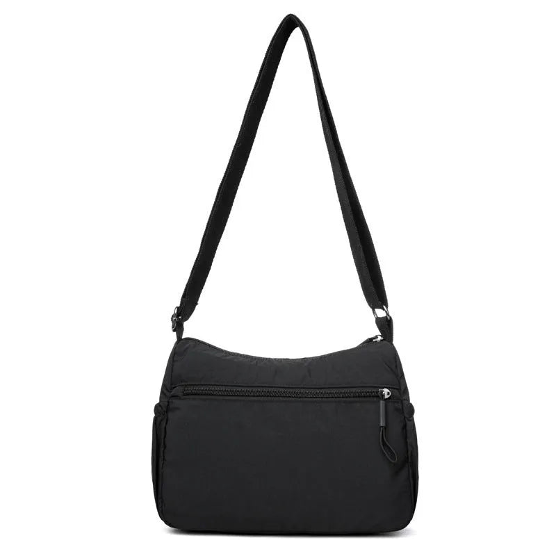 Trendy water-repellent nylon crossbody cloth bag in black with single shoulder strap and outer pocket