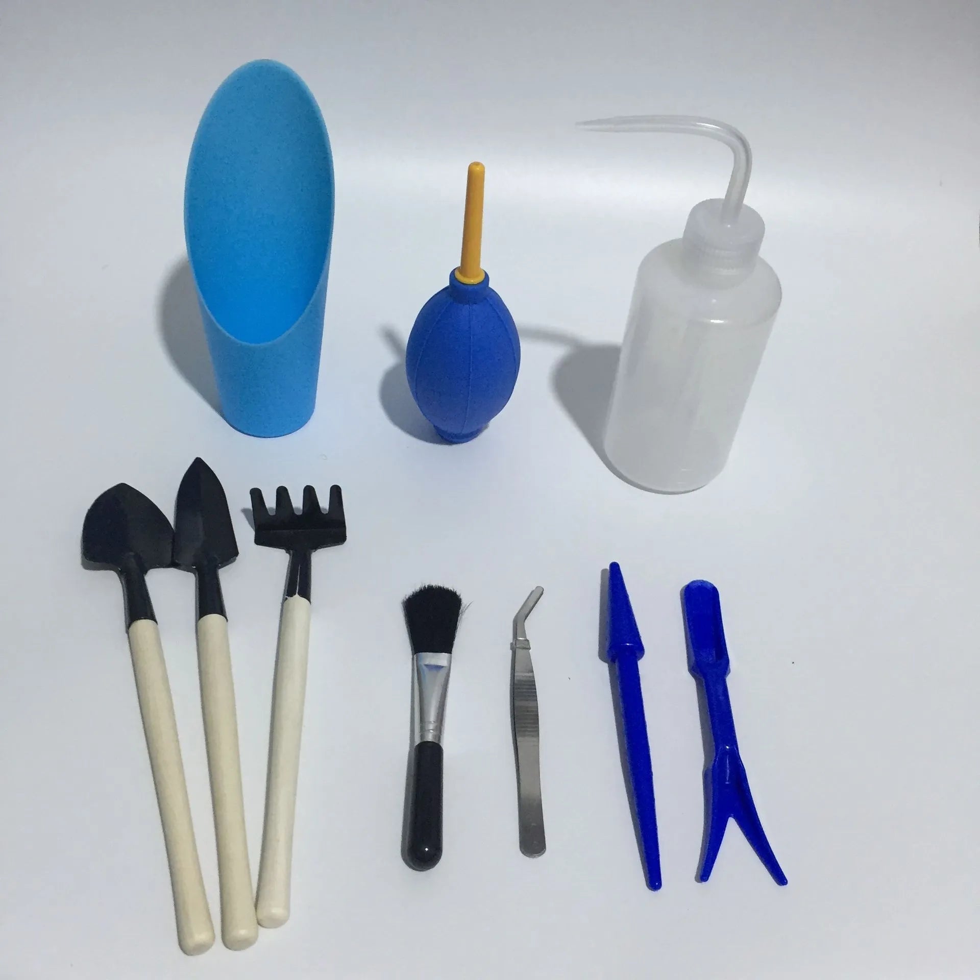 Succulent gardening tool set showing watering can, tweezers, mini shovel and brush for small plant care
