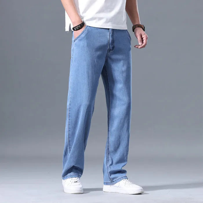 Man wearing loose straight-leg light blue Lyocell casual jeans with a zipper fly.