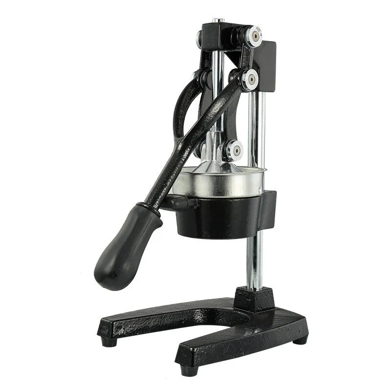 Black cast iron manual juicer with stainless steel strainer on a kitchen counter
