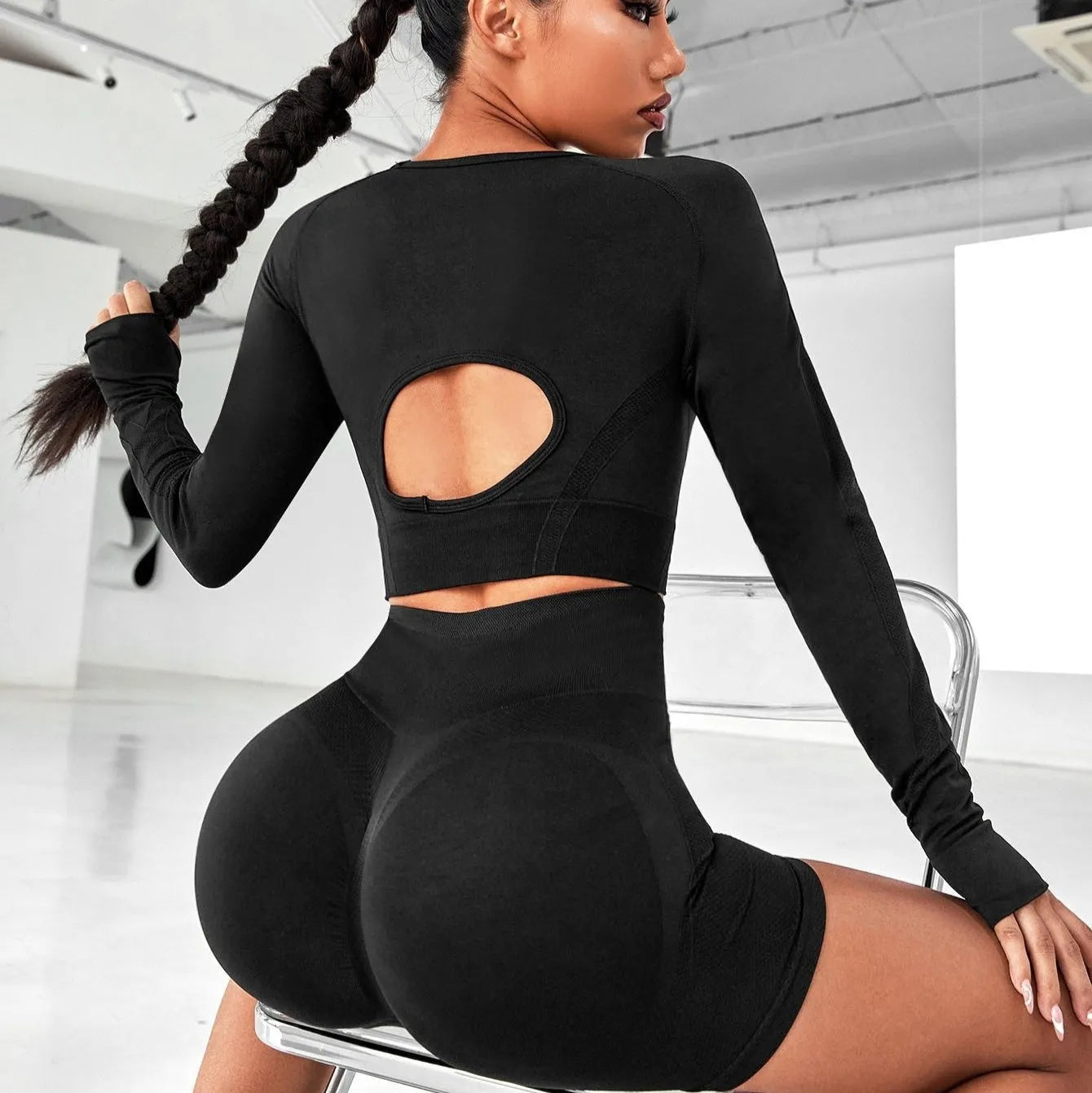 Women's black yoga suit set with high-waisted leggings and long sleeve top for fitness