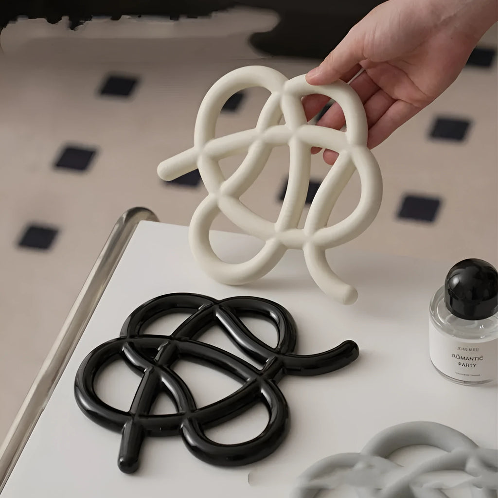 Ceramic heat proof mat in irregular shape on dining table surface