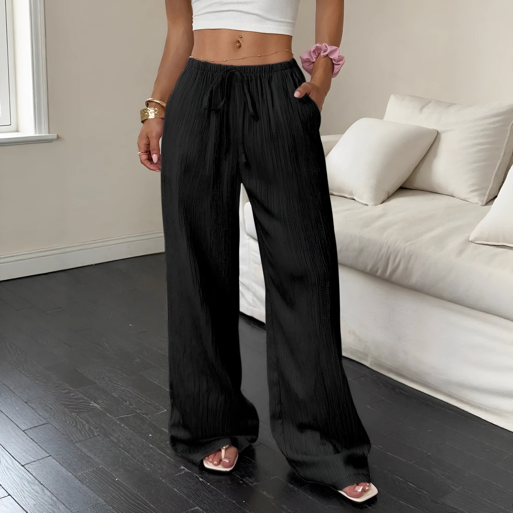 Women's black wide leg trousers with lace-up waist detail, shown with pink colour option