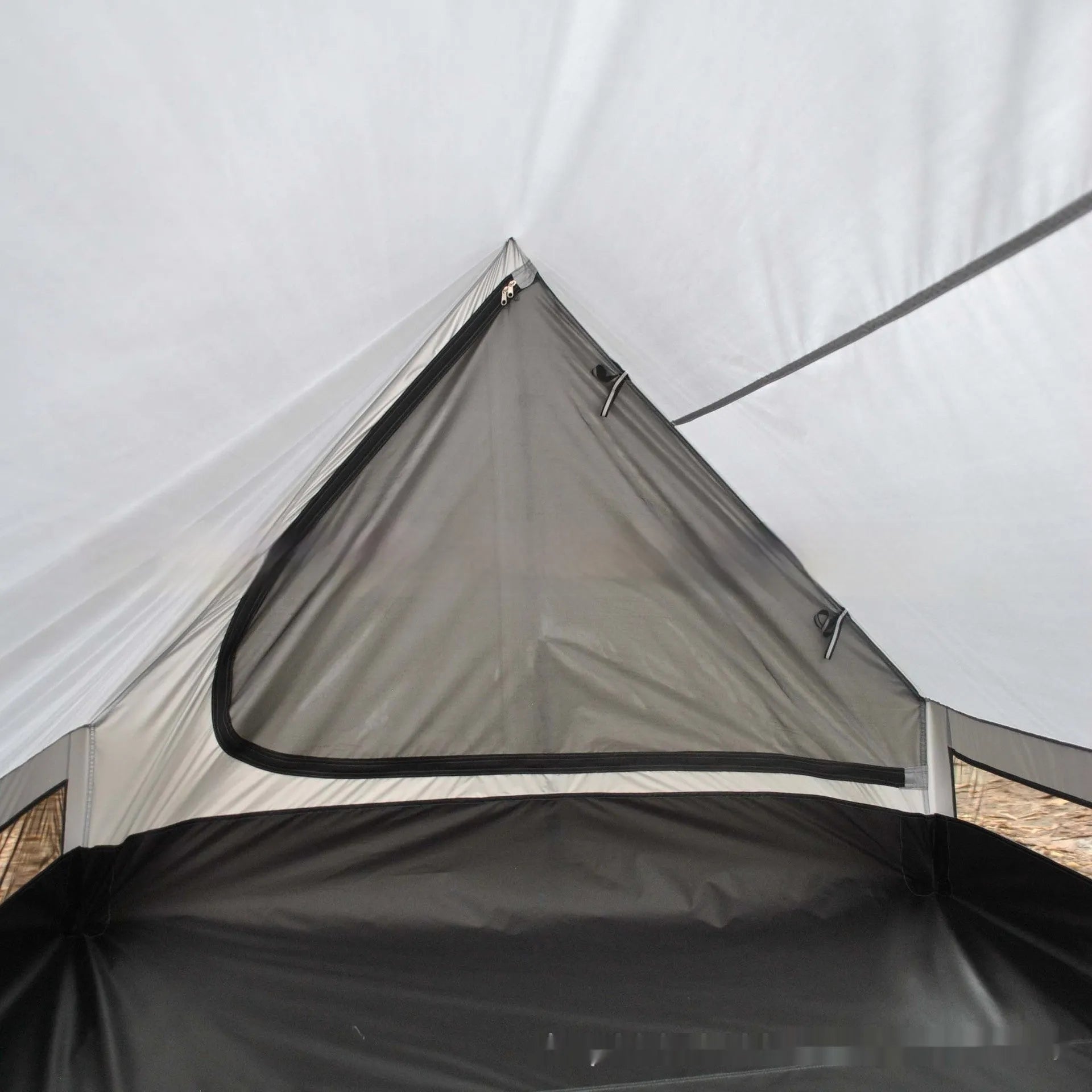 Brown or white A-line cabin tent pitched with trekking poles, showing spacious interior and waterproof fabric construction