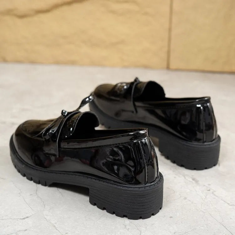 Women's brown and black loafer shoes with decorative bow detailing
