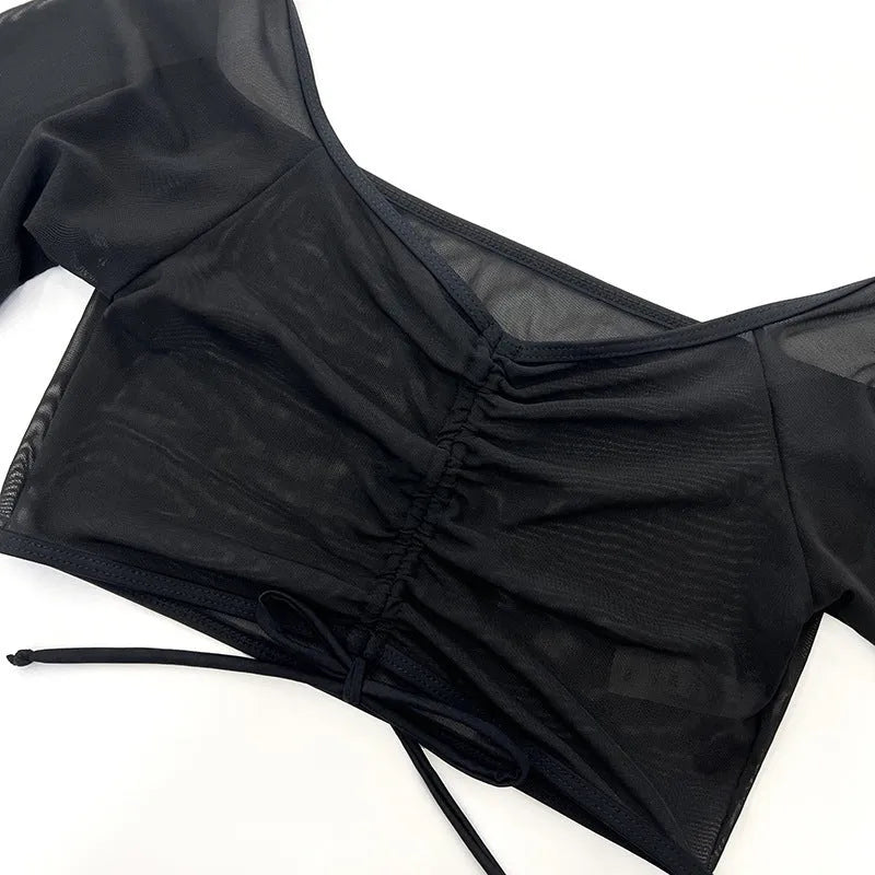 Black long sleeve mesh bikini top and briefs from a four-piece women's swimwear set.