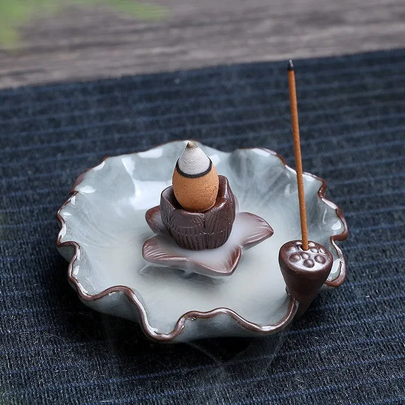 Square purple clay ceramic reverse flow incense burner with lotus and plum blossom decoration.