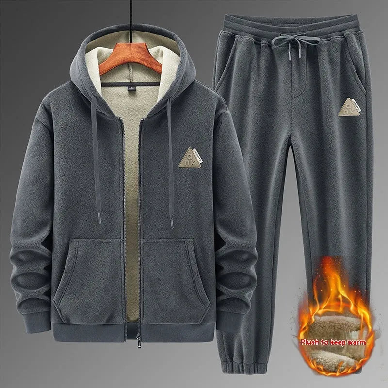 Casual grey sports suit set with a hooded cashmere-feel sweater and matching cotton-look pants on a hanger.