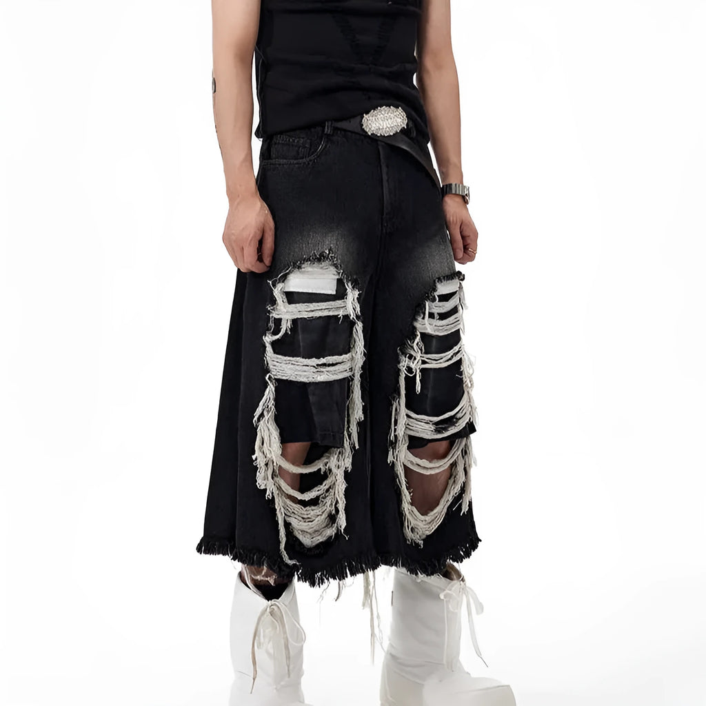 Black cropped wide-leg jeans with ripped patch detail on the leg, showing a mid-high waist and loose fit.