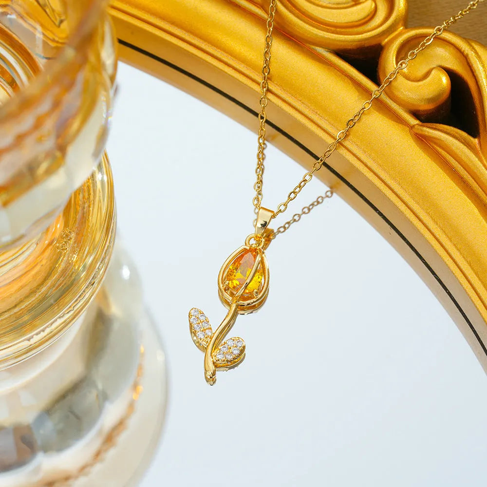 Gold zircon tulip flower pendant necklace on an adjustable titanium steel chain.