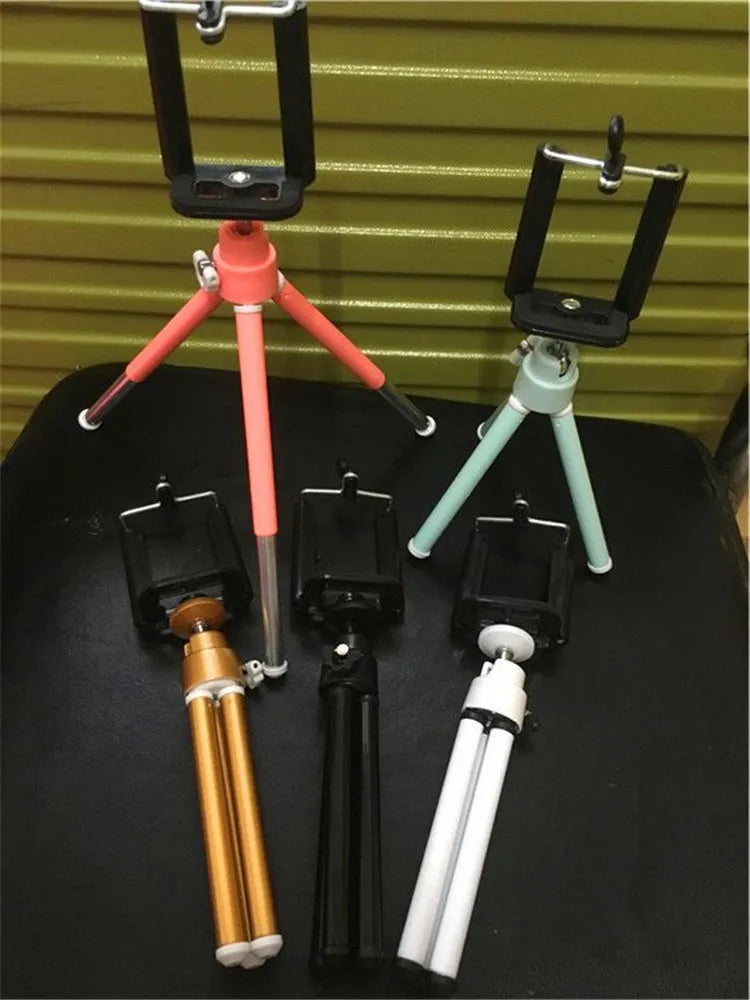 Black or silver desktop phone holder with a two-section adjustable bracket.