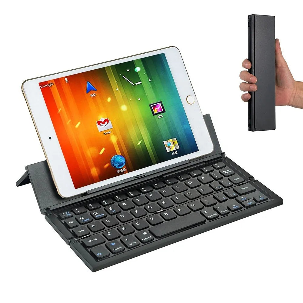 Black folding Bluetooth wireless keyboard next to tablet showing compact portable design