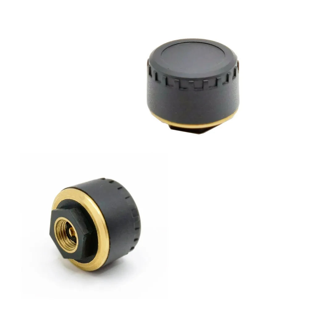 Four black Bluetooth tyre pressure sensors for mobile app monitoring system