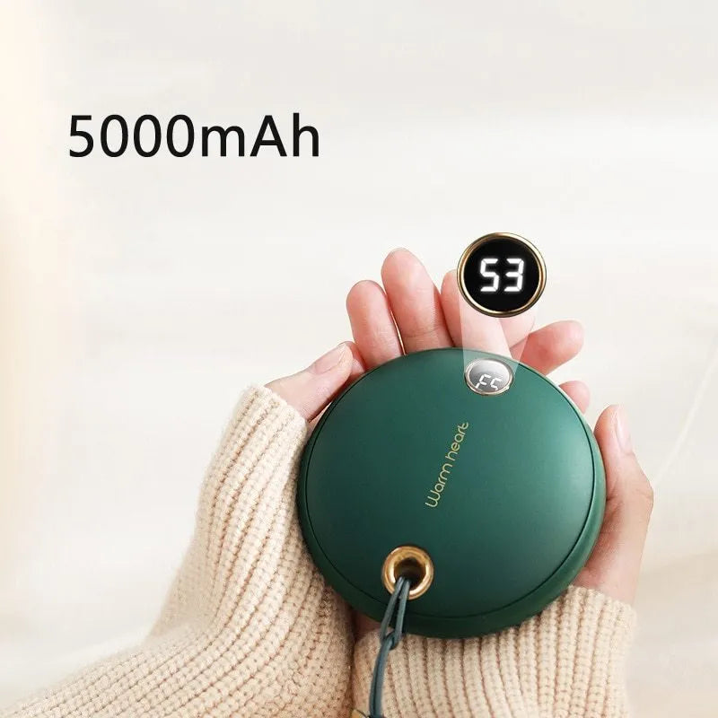 Green hand warmer power bank with digital display showing battery percentage, next to charging cable