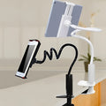 Black flexible gooseneck mount holder with suction base gripping a mobile phone