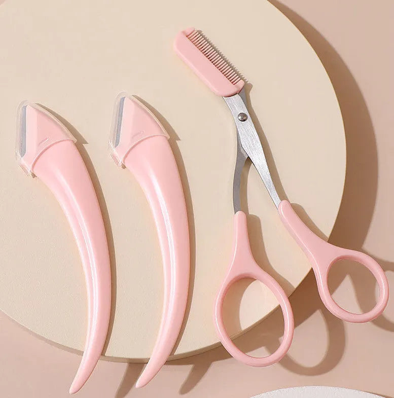 Close-up of a white and pink eyebrow trimming knife with a small comb attached on a plain background.