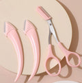 Close-up of a white and pink eyebrow trimming knife with a small comb attached on a plain background.