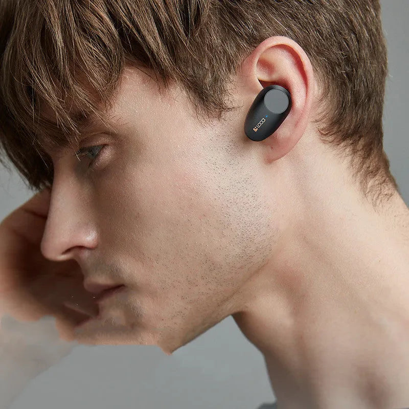 Black wireless Bluetooth headset with earpieces and charging stand, featuring ANC noise reduction.