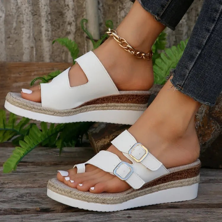 White woven patent leather peep toe wedge sandals on a rubber sole