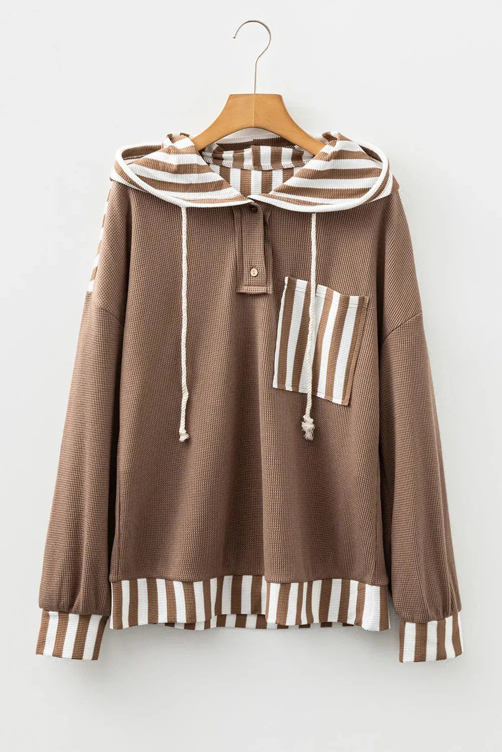 Straw yellow hoodie with waffle texture and striped patchwork design featuring drawstring hood and button neck closure