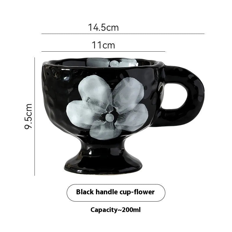 Hand-pinched irregular shaped ceramic mug in a solid colour, shown from the side.