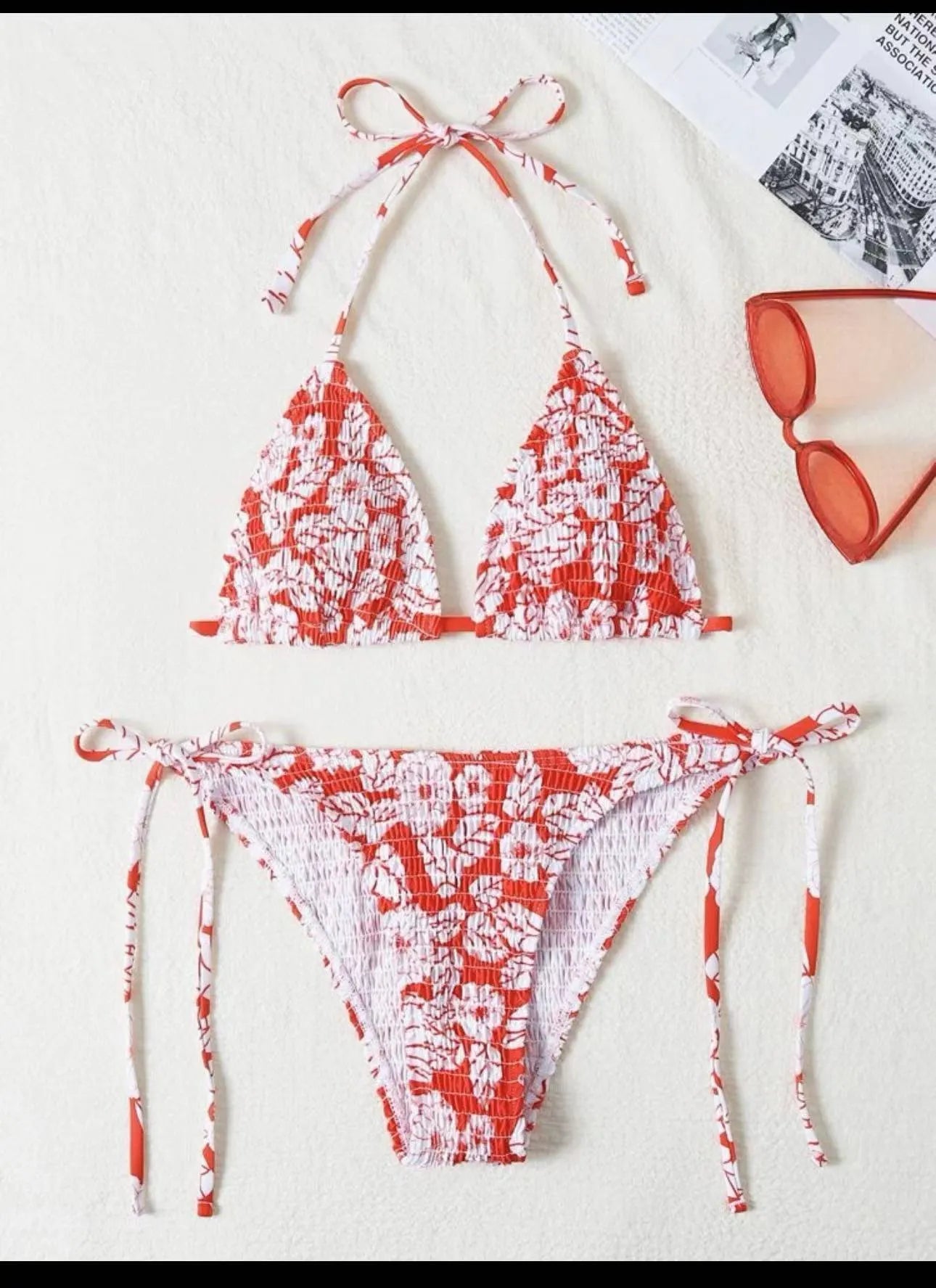 Women's pink floral halter neck swimsuit top and briefs set on a neutral background