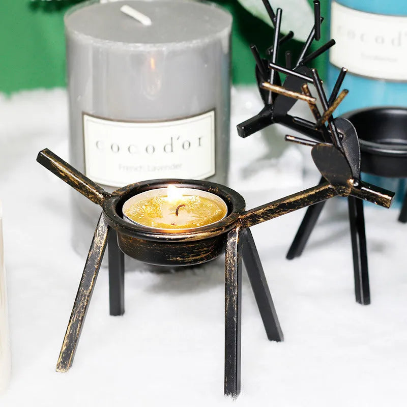 Black iron Christmas candlestick holder with detailed elk and deer design
